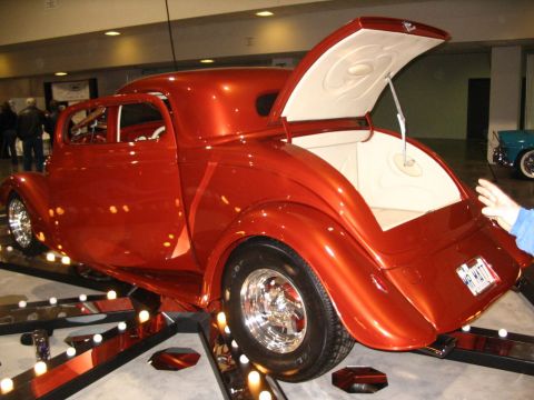 1993 Ford Taurus - A custom hot rod coupe is displayed with its trunk open, revealing a clean interior and a personalized license plate.