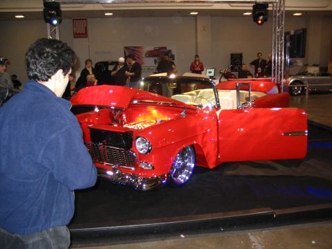1993 Ford Taurus - Customized 1955 Chevrolet Bel Air convertible displayed with its hood and door open at a show.