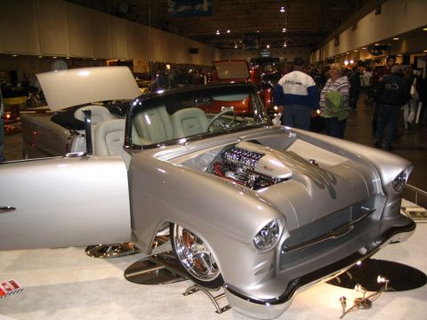 1993 Ford Taurus - Customized 1955 Chevrolet Bel Air convertible displayed indoors with its hood open, revealing a powerful engine.