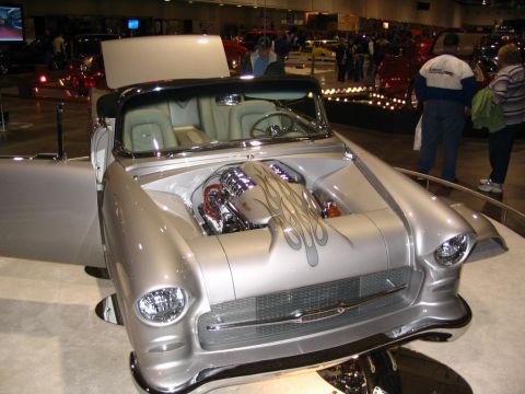 1993 Ford Taurus - A highly customized 1955 Chevrolet Bel Air convertible is displayed with its hood and door open.