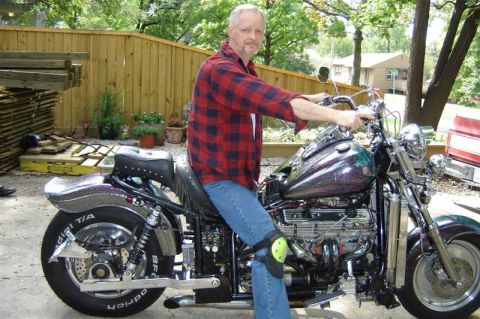 1994 Ford Probe - Man on a custom motorcycle with a sparkly paint job and studded seat.