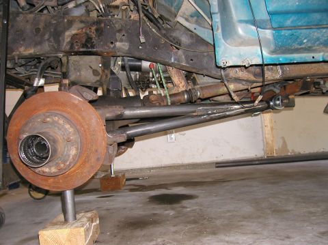 1984 Ford Bronco - Underbody view of a vehicle's suspension system, showing the brake rotor and driveshaft.