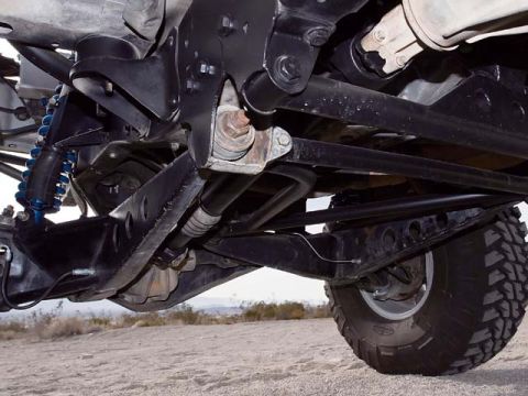 1984 Ford Bronco - Close-up view of the undercarriage, showing suspension components and a large tire. The registry claims 1984 Ford Bronco, but this is uncon…