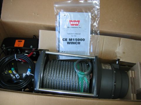 1992 Ford Mustang - New Warn CE M15000 winch and its operator's manual are shown packed in a cardboard box.