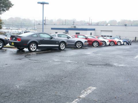 2001 Mercury Grand Marquis - A line of Ford Mustangs are parked in a lot on a cloudy day. The website Supermotors.net is visible in the lower right corner.