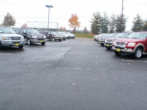 2001 Mercury Grand Marquis - A lot filled with various Ford SUVs and trucks, likely at a dealership.