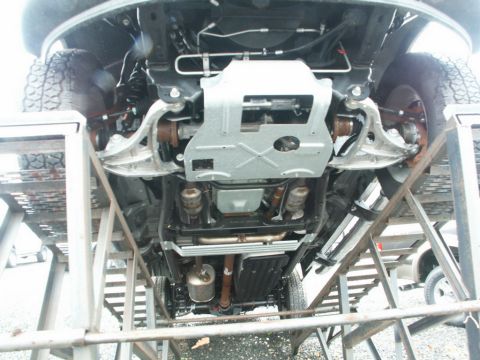 2001 Mercury Grand Marquis - The underside of a vehicle is shown, revealing the suspension components, exhaust system, and underbody protection.