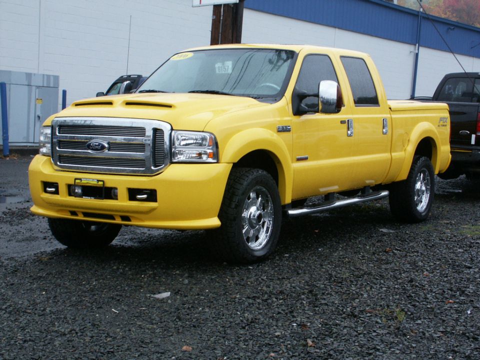Yellow Ford F-250 Super Duty truck with chrome accents and a hood scoop