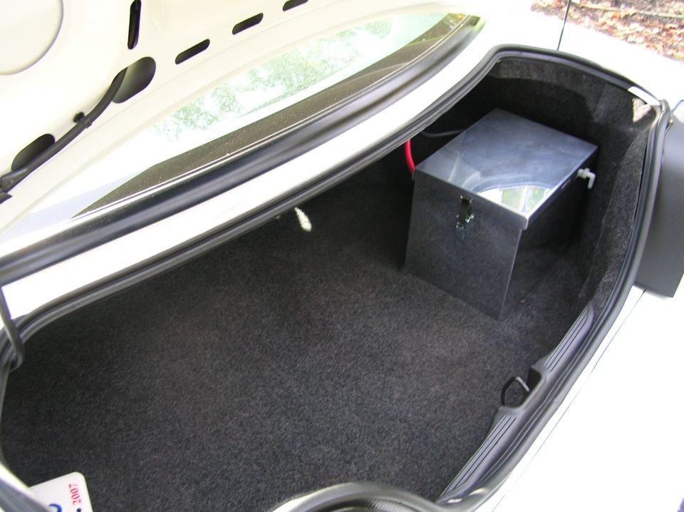 Trunk interior with a metal tank and red wire