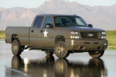 1974 Ford F-100 - Olive drab pickup truck with white star emblem on door, front quarter view.