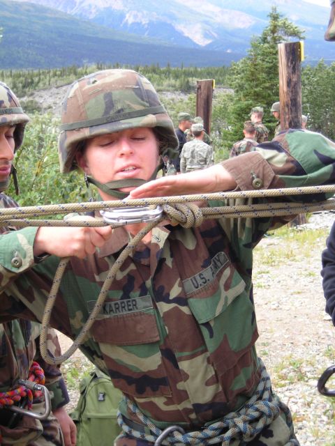 2003 Jeep TJ - US Army soldiers train in rappelling techniques using ropes and carabiners in a mountainous outdoor environment.