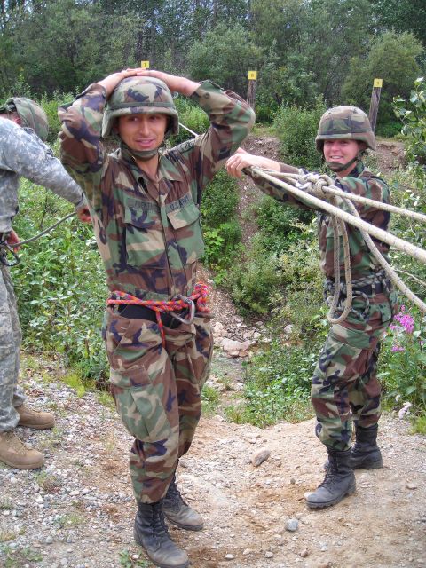2003 Jeep TJ - Soldiers in camouflage uniforms and helmets are seen outdoors with ropes.