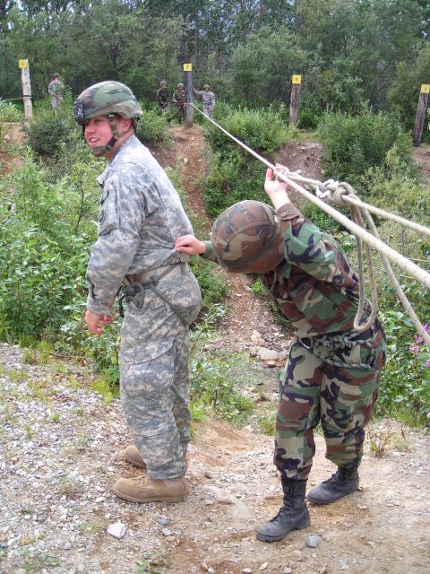2003 Jeep TJ - Two soldiers participate in a rope-pulling exercise as part of a military training event.