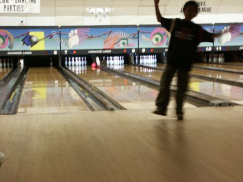 2001 Mercury Grand Marquis - A person is about to bowl at Oakwood Lanes, with bowling pins set up on the lanes.