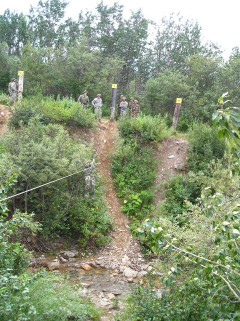 2003 Jeep TJ - Military personnel undergo training on a challenging obstacle course involving rappelling down a incline.