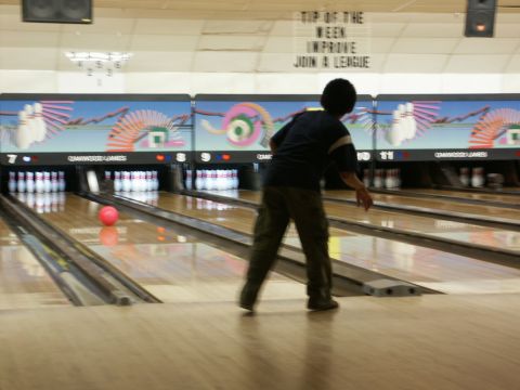 2001 Mercury Grand Marquis - A person bowls in a bowling alley with "TOP OF THE WEEK IMPROVE JOIN A LEAGUE" signage visible.