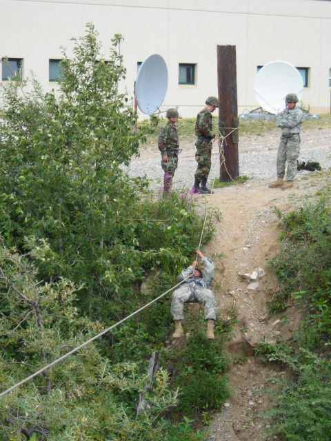 2003 Jeep TJ - Military personnel engage in a training exercise involving rappelling down a steep incline.