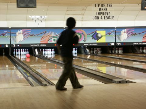 2001 Mercury Grand Marquis - A person is bowling at Oakwood Lanes, with pins set up on the lanes.
