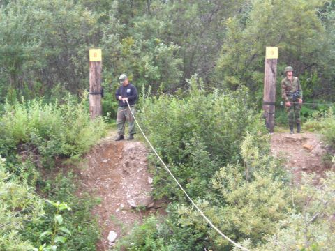 2003 Jeep TJ - Two soldiers participate in an outdoor training exercise involving ropes and marked posts.