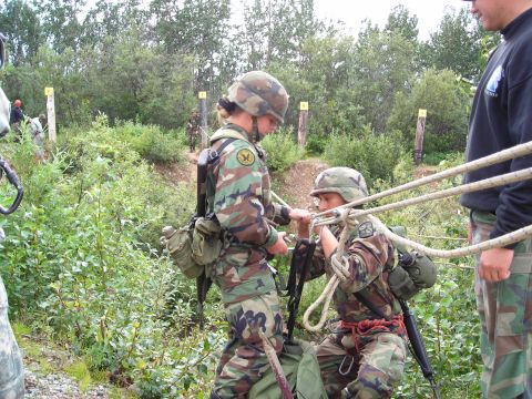 2003 Jeep TJ - Military personnel train with ropes and harnesses in an outdoor environment.