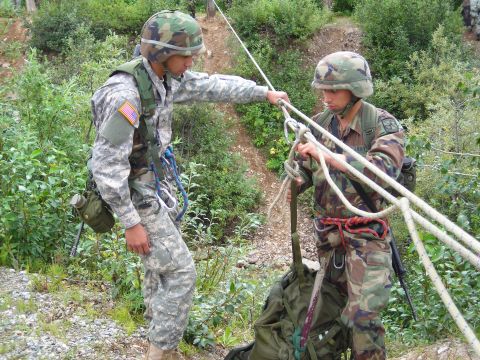 2003 Jeep TJ - Soldiers prepare for a rappelling exercise in a natural outdoor environment.