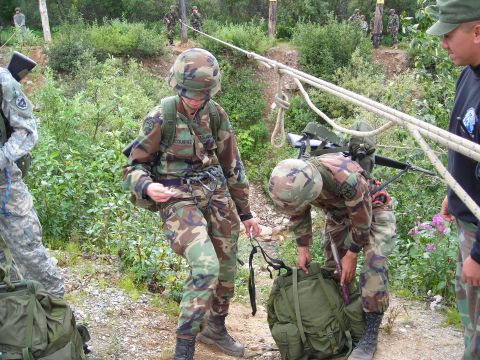 2003 Jeep TJ - Military personnel train on a rope system outdoors, with several individuals visible in the background.