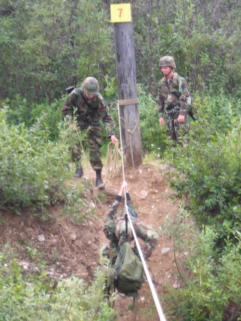 2003 Jeep TJ - Military personnel practice rappelling techniques during training exercises in a wooded area.