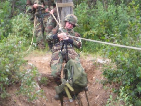 2003 Jeep TJ - Soldiers practice rappelling down a wooded slope using ropes and safety harnesses.