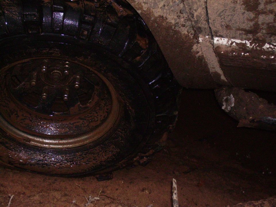 Mud-covered tire and fender of an off-road vehicle