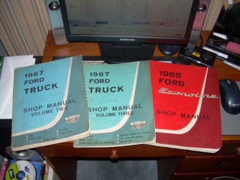 1971 Ford F-100 - Three shop manuals are displayed on a desk, two for 1967 Ford Trucks and one for a 1965 Ford Econoline.