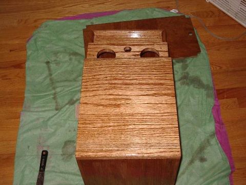 1985 Ford Bronco - A wooden center console part is shown on a green cloth, with a tool visible on the cloth.