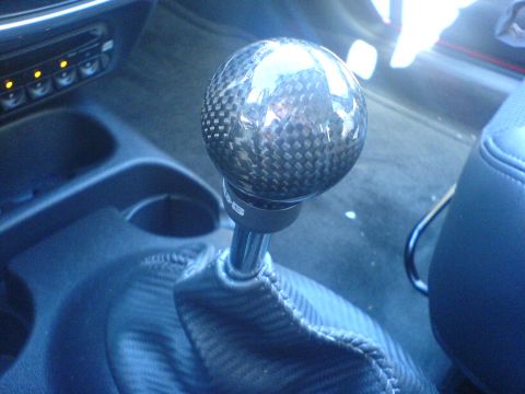 2005 Dodge SRT-4 - Interior shot of a carbon fiber shift knob and boot, likely an aftermarket part.