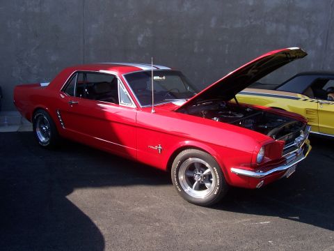 2002 Ford Mustang - Red classic Ford Mustang coupe parked outdoors with hood open, another car visible behind it.