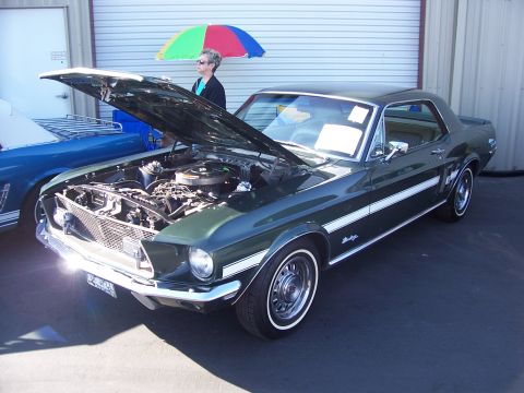 2002 Ford Mustang - A 1967 Ford Mustang coupe is displayed with its hood open, parked next to another vehicle.