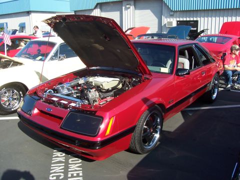 2002 Ford Mustang - Red Ford Mustang from the mid-1980s is displayed with its hood open.