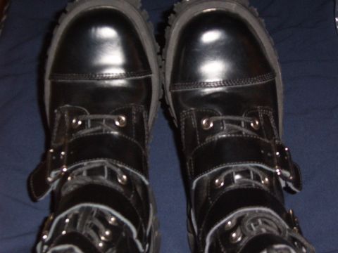 1993 Ford Bronco - A close-up view of black leather boots with multiple straps and buckles.