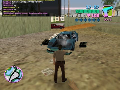 1990 Ford Probe - A virtual car is heavily damaged in a video game scene, with a character standing nearby.