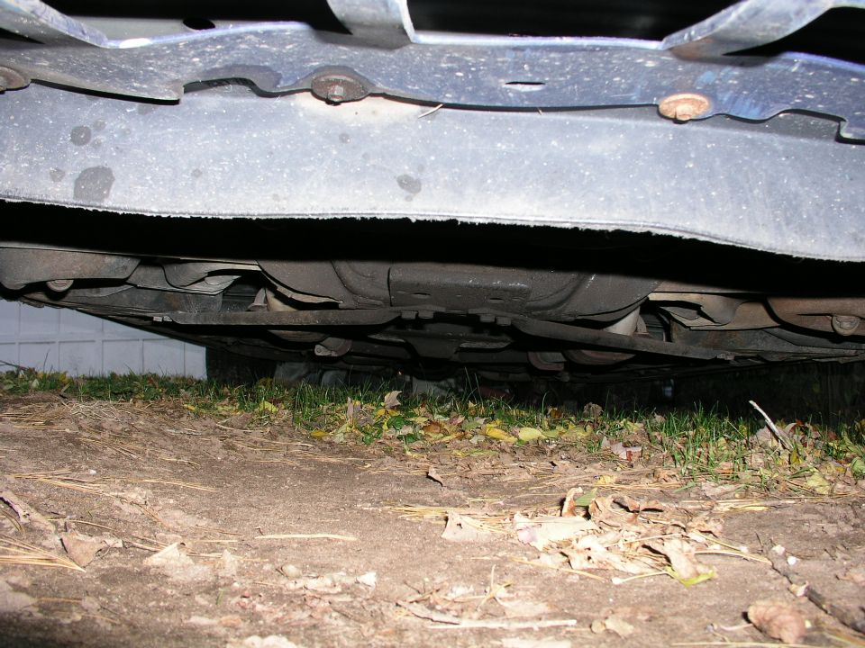 Undercarriage view of a vehicle with visible suspension components and exhaust system