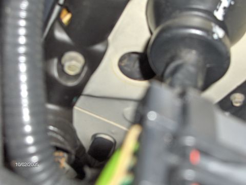 1996 Mercury Grand Marquis - THe hole. THis is where the shifter cable used to go. I used a 1-5/8" iirc black rubber tapered plug from lowes to fill it. Works great! An…