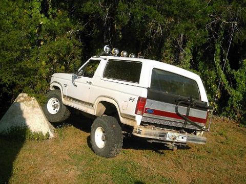 1986 Ford Bronco - This 1986 Ford Bronco is shown navigating an obstacle on a grassy incline.