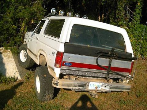 1986 Ford Bronco - This 1986 Ford Bronco is shown from the rear, equipped with off-road tires and a bike rack.