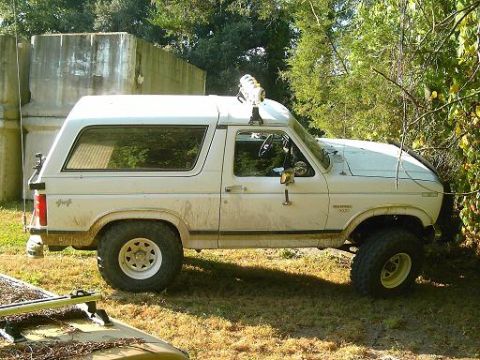 1986 Ford Bronco - This 1986 Ford Bronco is modified for off-road use and parked in a grassy area.
