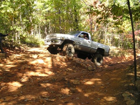 1996 Ford Bronco - A lifted pickup truck navigates a challenging off-road course.