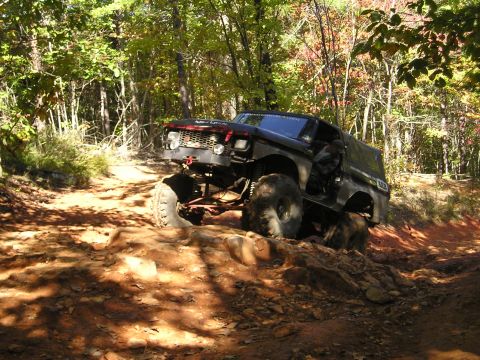 1996 Ford Bronco - This heavily modified SUV navigates a rocky off-road trail during an outdoor excursion.