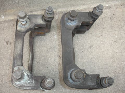 1993 Ford Taurus - Two brake caliper brackets are shown, likely for a vehicle's braking system upgrade.
