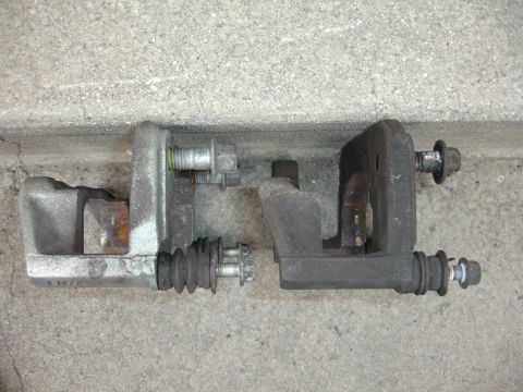 1993 Ford Taurus - Comparison of two brake calipers, likely for a vehicle upgrade or replacement.