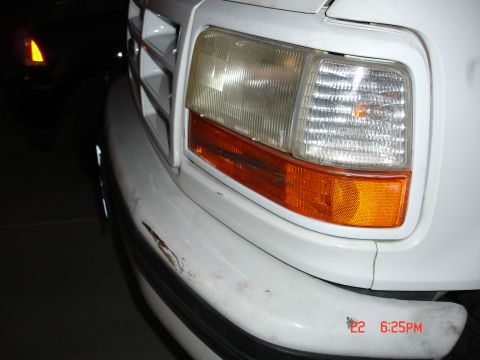 1996 Ford Bronco - Front corner view of a white 1996 Ford Bronco, showing a damaged bumper and headlight assembly.
