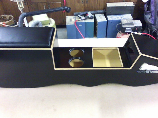 Custom black center console with two cupholders and a recessed tray