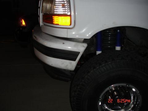 1996 Ford Bronco - Close-up of a truck's front fender, bumper, and tire, with a timestamp and website overlay.