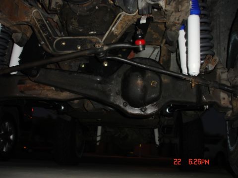 1996 Ford Bronco - Undercarriage view of a vehicle's suspension and drivetrain components.